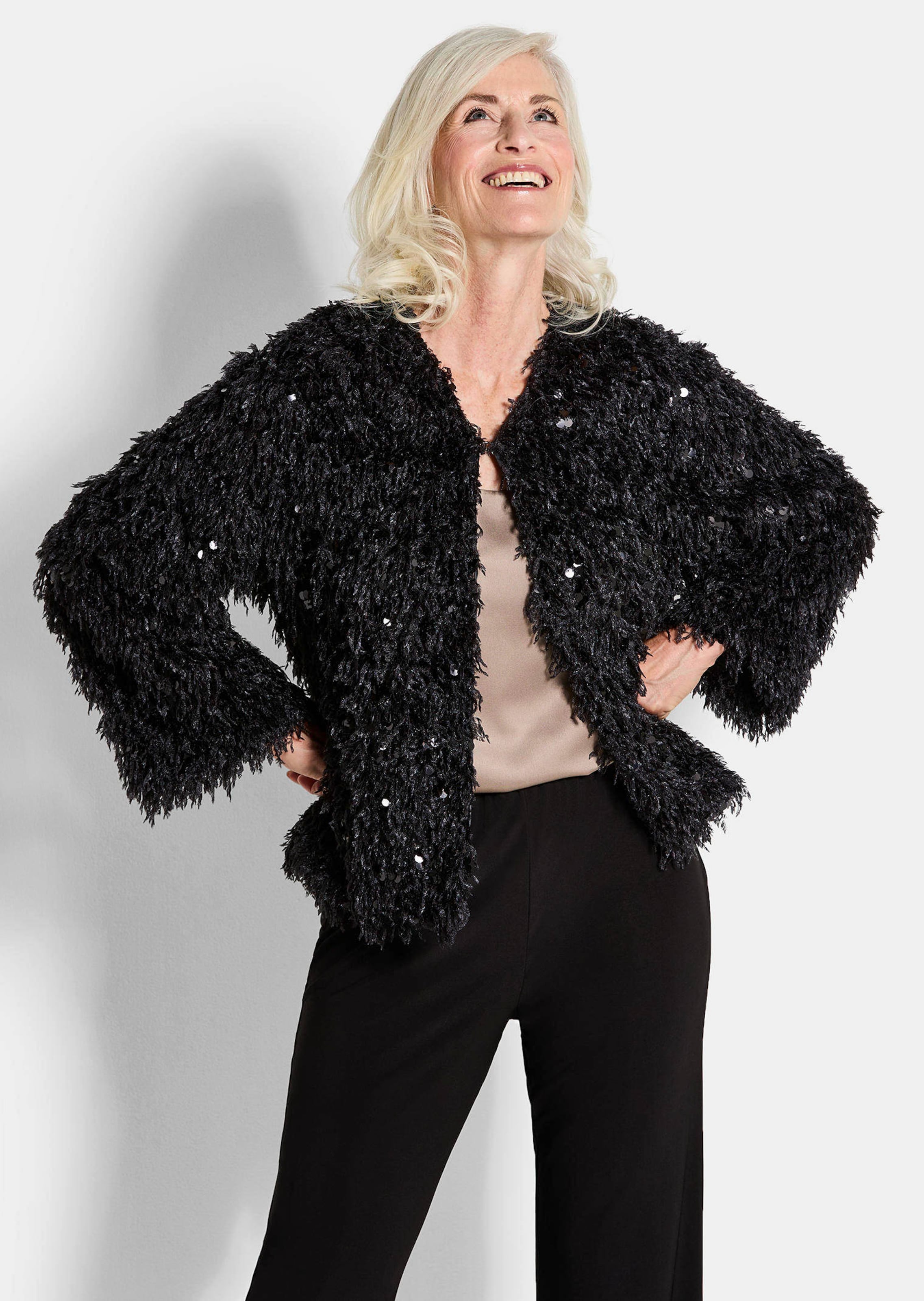 Veste aspect plumes, orné de paillettes