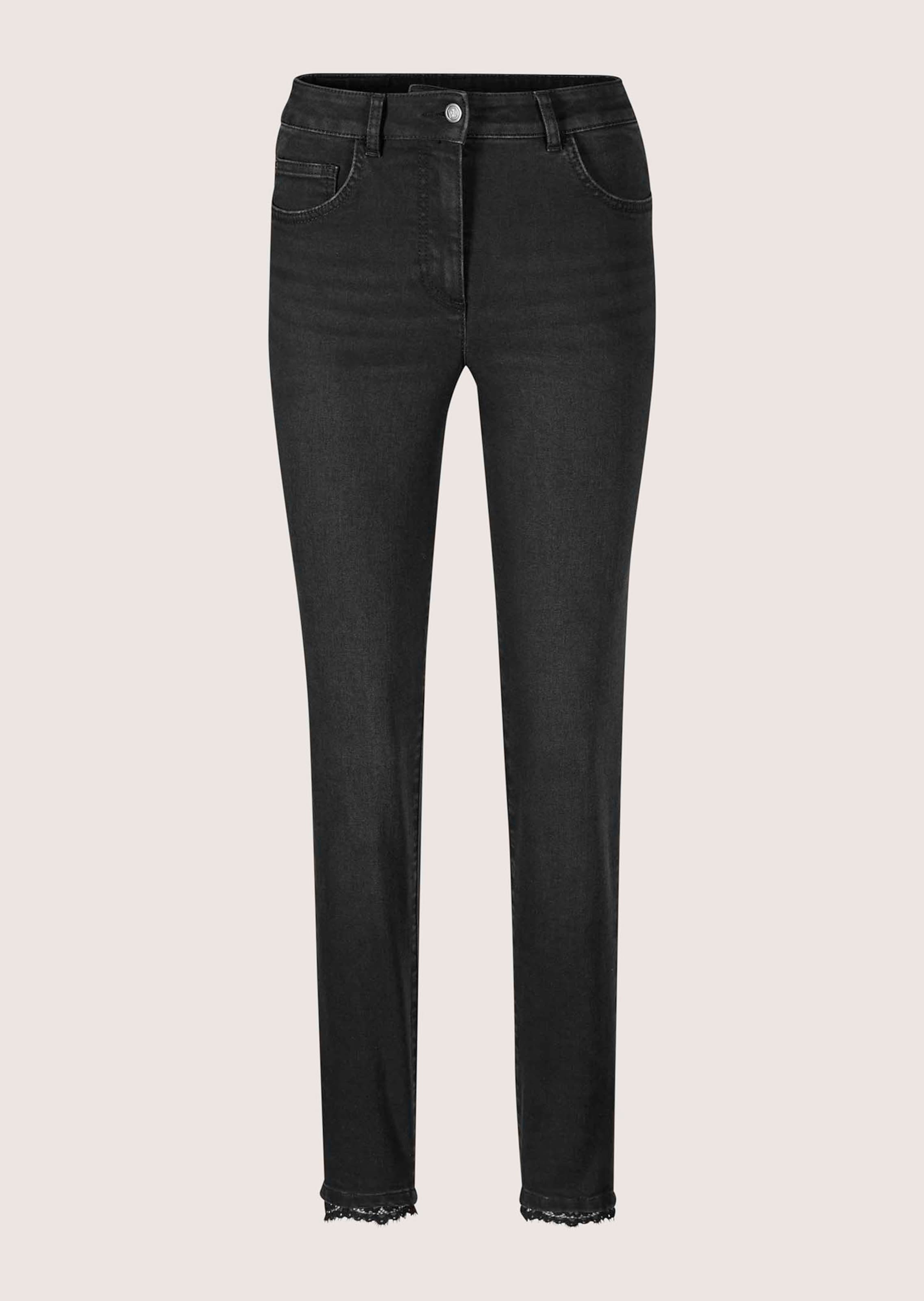 Slim-fit jeans with lace hem detail