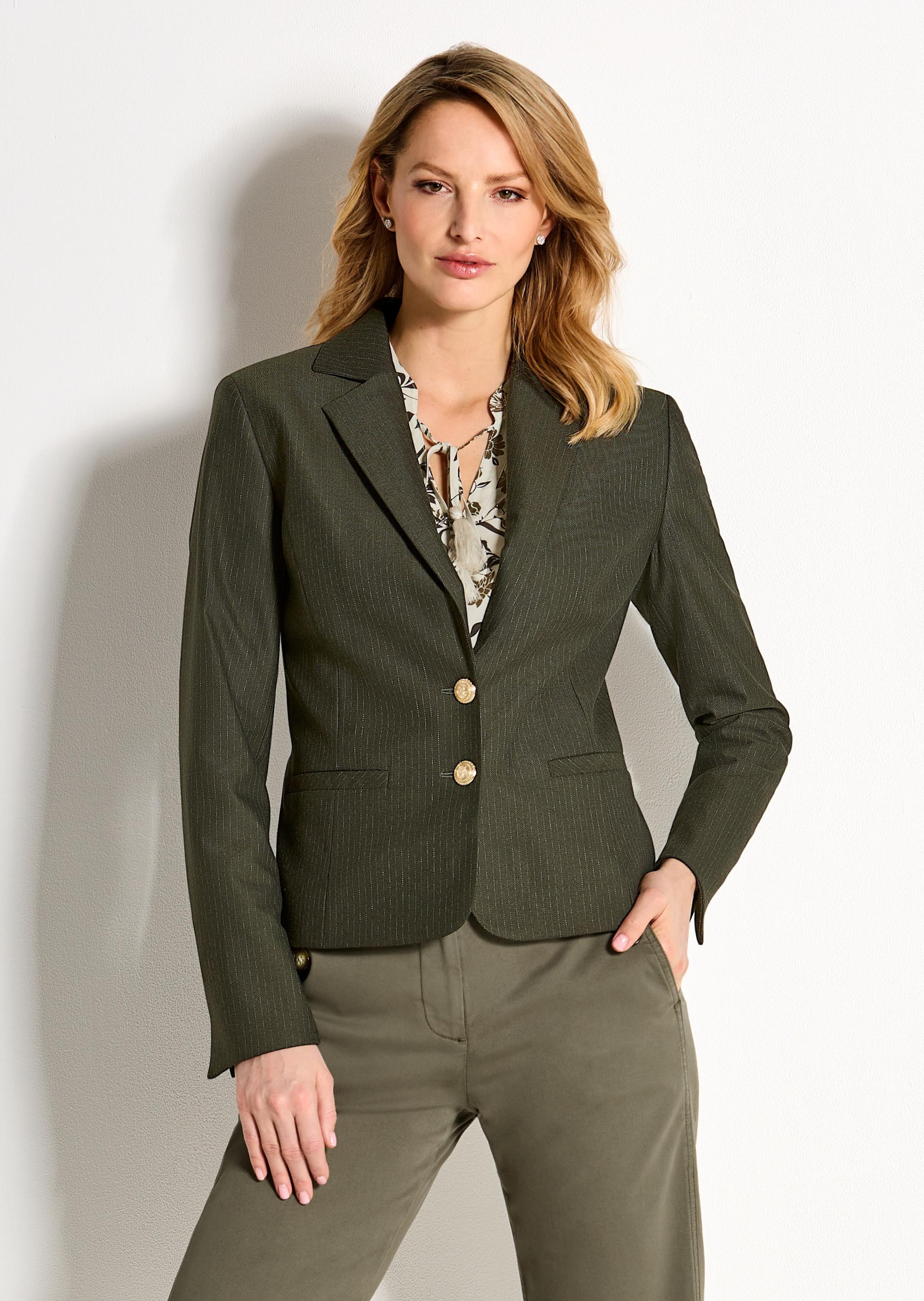A pinstripe blazer featuring gold-coloured heraldic buttons