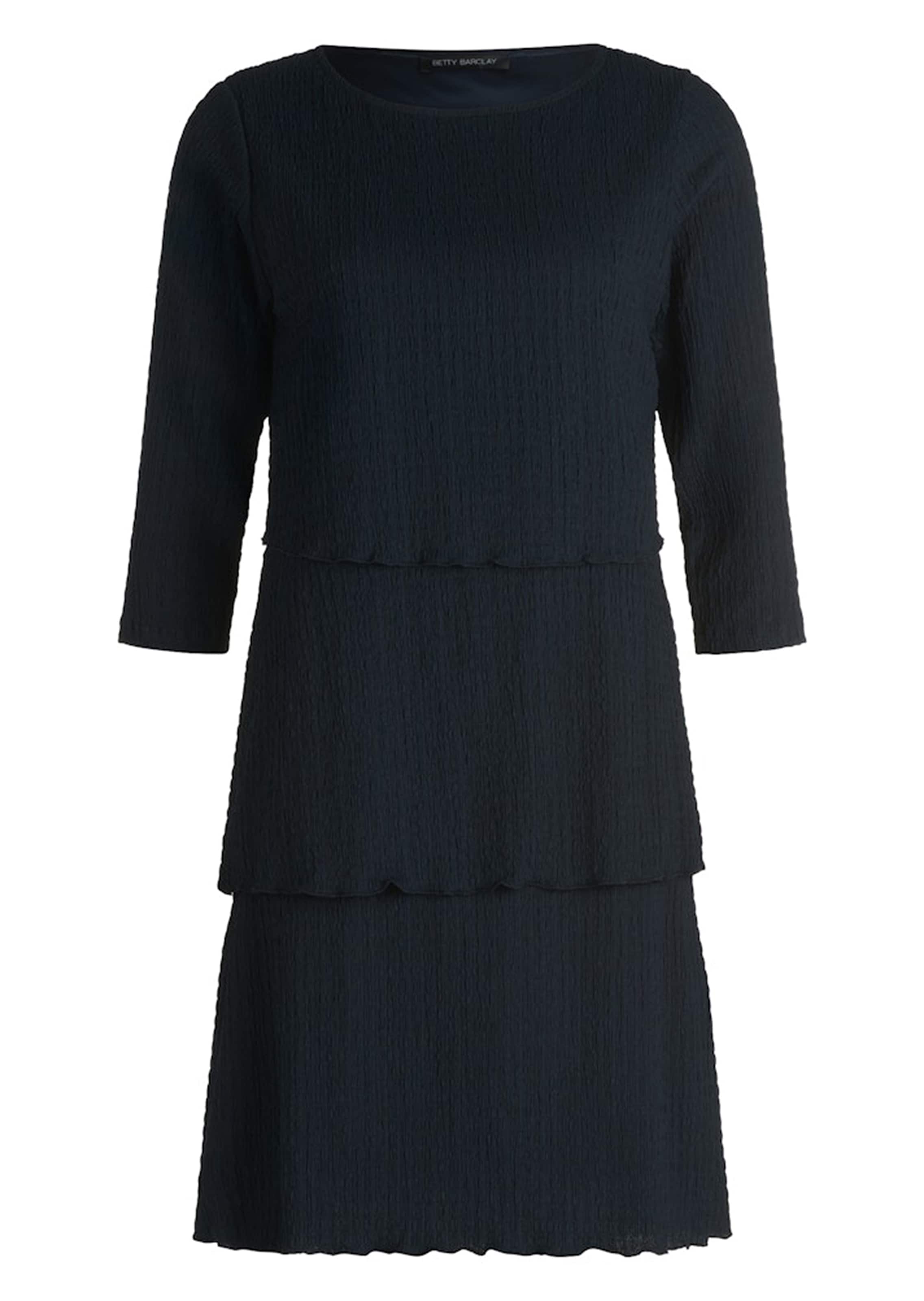 Elegantti kerrosmekko aaltomaisella helmalla